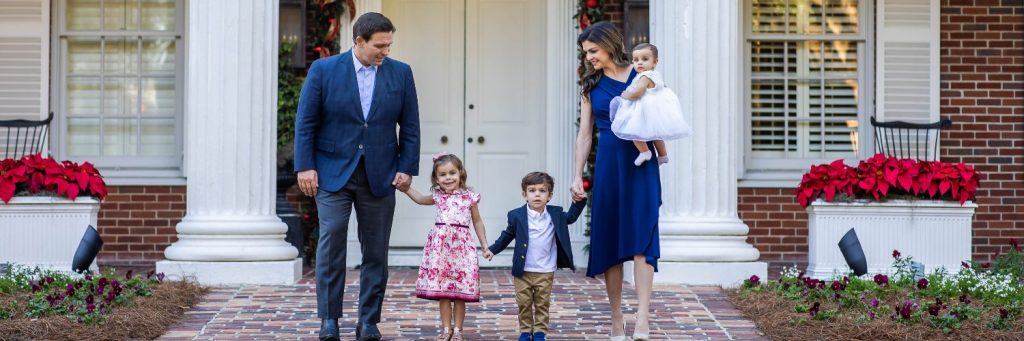 Family walking out of their house holding hands